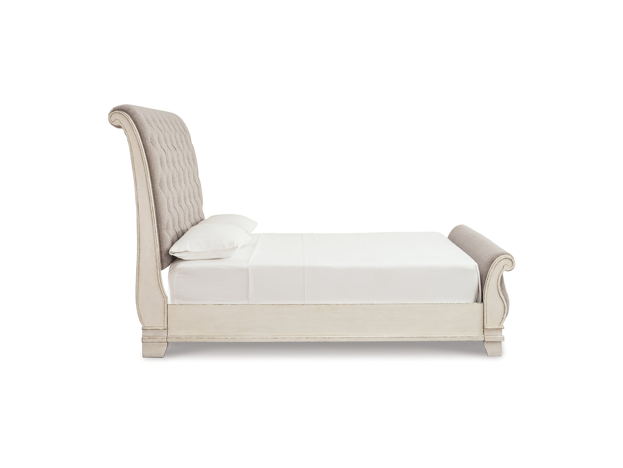 Realyn Two-Tone Queen Upholstered Sleigh Bed And Chest
